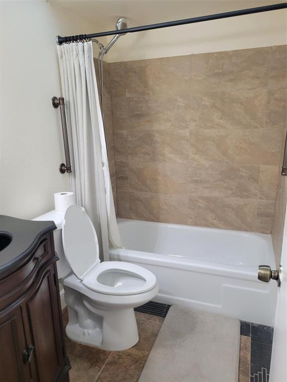 10032 65th Avenue North, Unit 8 St. Petersburg, FL 33708 - Photo 16 of 61 a white toilet and tub sitting next to a bathroom sink