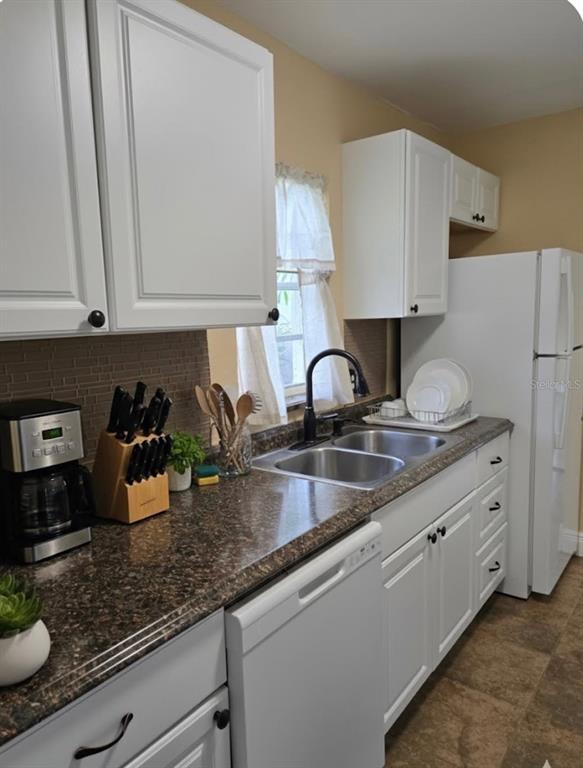 10032 65th Avenue North, Unit 8 St. Petersburg, FL 33708 - Photo 2 of 61 a kitchen with granite countertop a sink a stove and cabinets