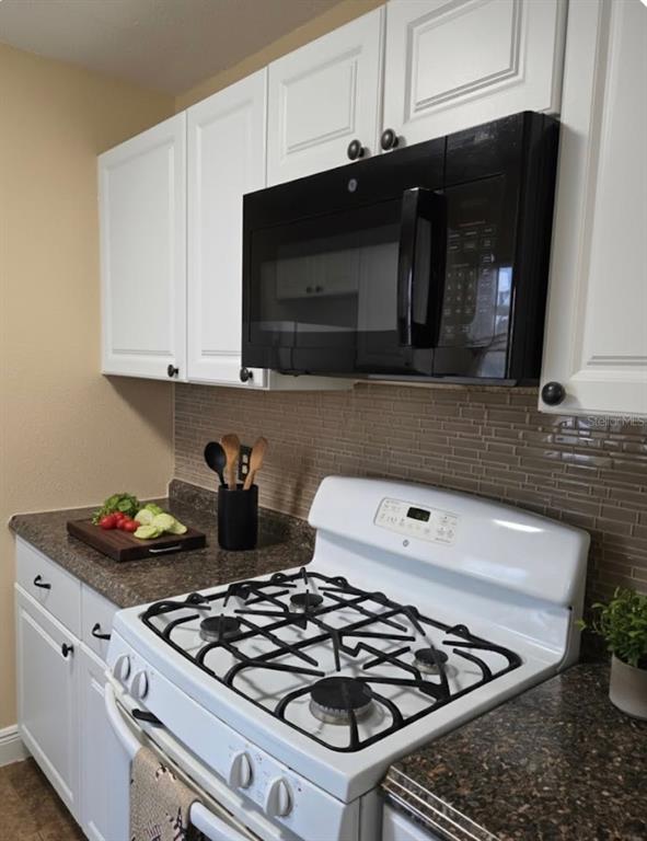 10032 65th Avenue North, Unit 8 St. Petersburg, FL 33708 - Photo 3 of 61 a kitchen with a stove and a microwave