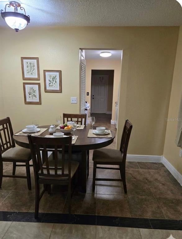 10032 65th Avenue North, Unit 8 St. Petersburg, FL 33708 - Photo 4 of 61 a view of a dining room with furniture and wooden floor