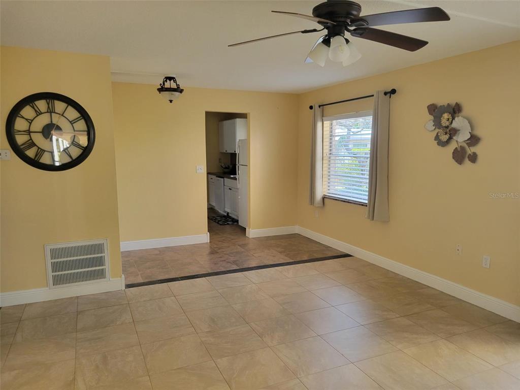 10032 65th Avenue North, Unit 8 St. Petersburg, FL 33708 - Photo 8 of 61 a view of a livingroom with a fan and a window