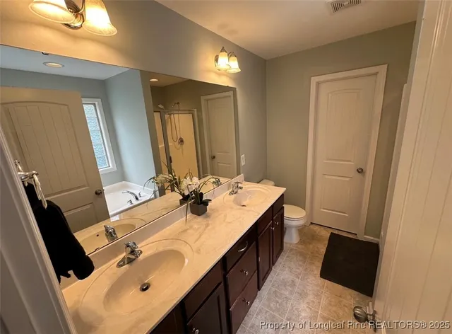 a bathroom with a sink double vanity and a mirror