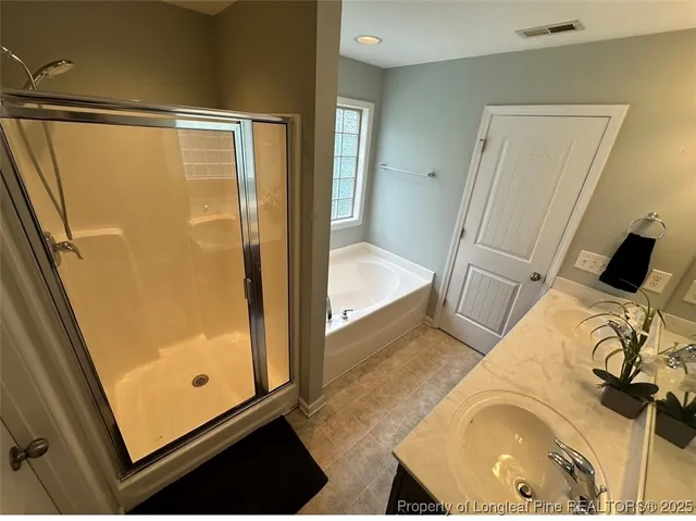 a bathroom with a tub and shower