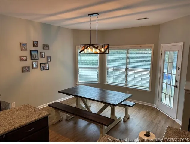 a dining room with furniture and window