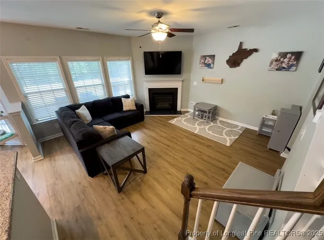 a living room with furniture fireplace and flat screen tv