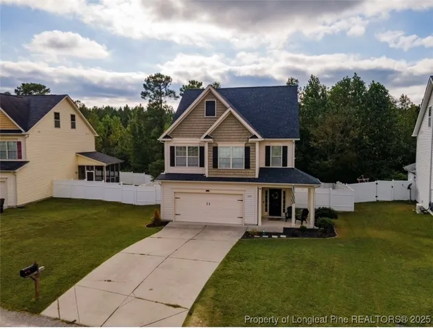 a front view of a house with a garden and deck