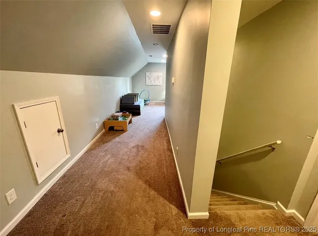 a view of a hallway with paintings on the wall