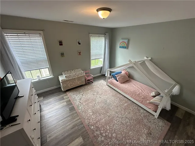 a bedroom with furniture and a window