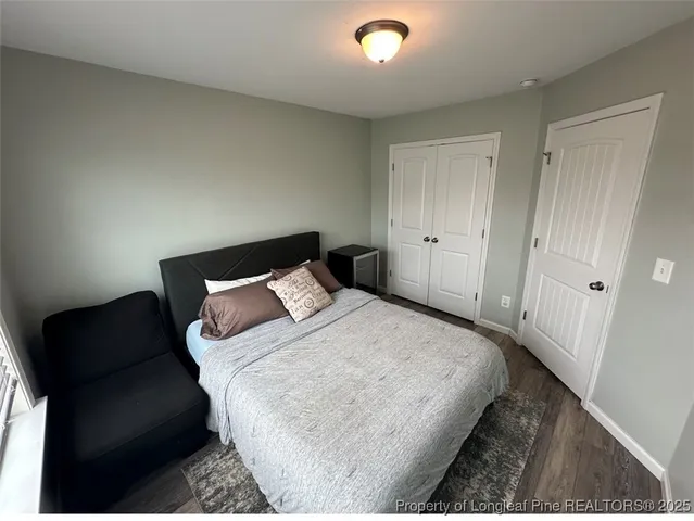 a bedroom with a bed and a couch