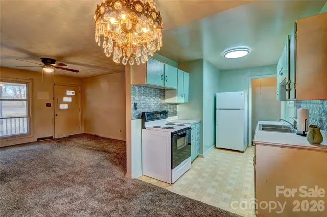 a kitchen with stainless steel appliances granite countertop a sink a stove and a refrigerator