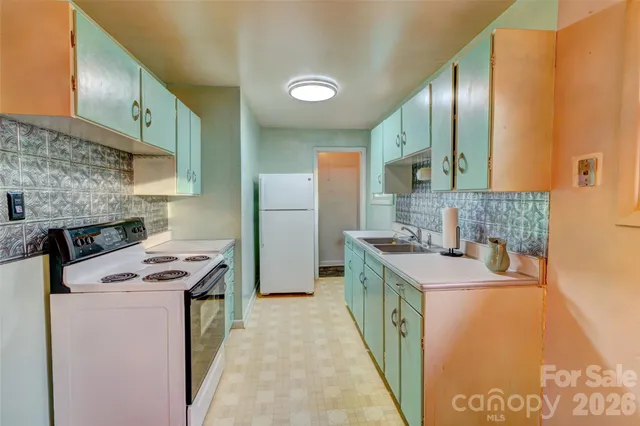 a kitchen with a sink stove and refrigerator