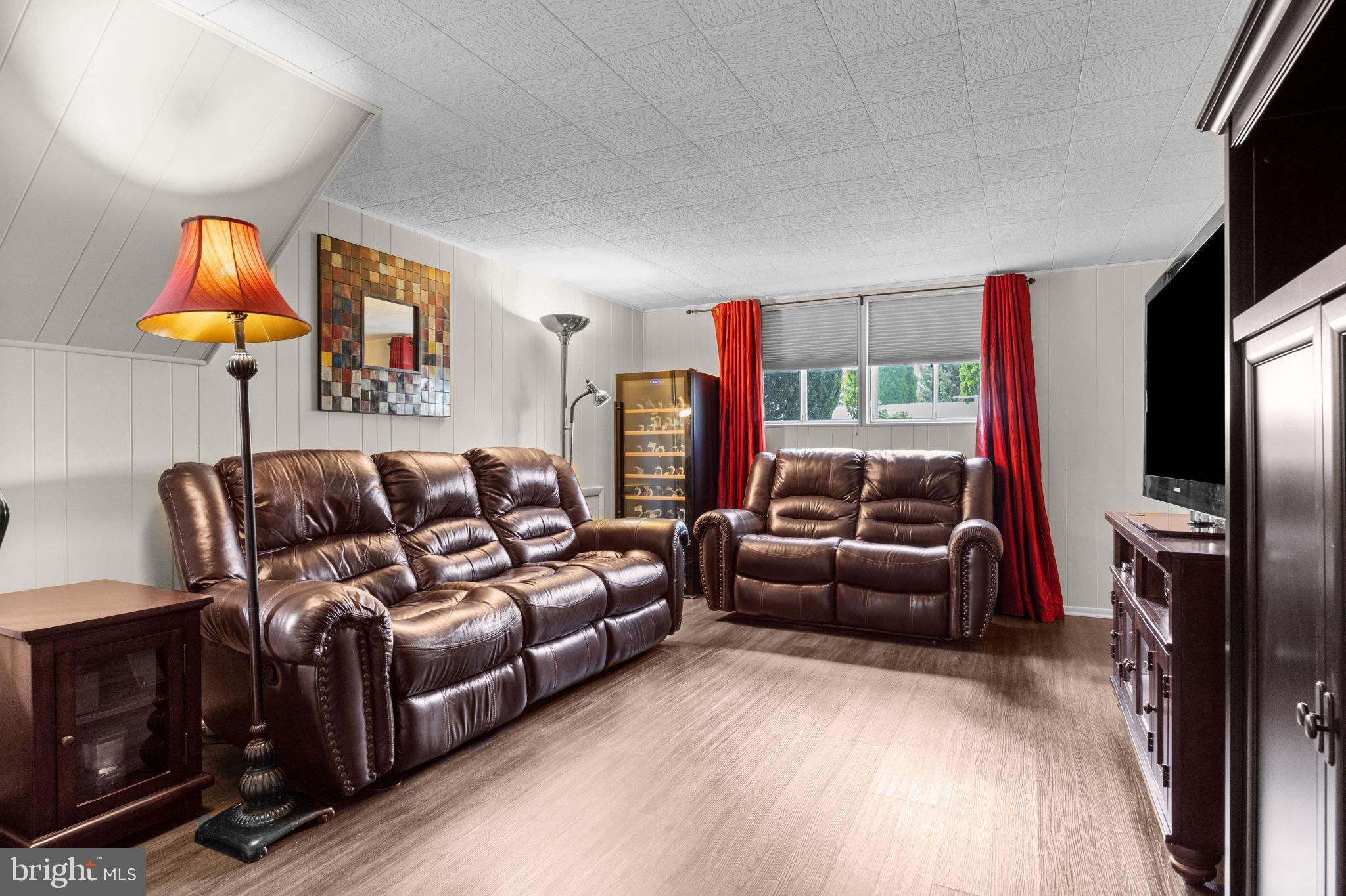 3166 Hulmeville Road Bensalem, PA 19020 - Photo 23 of 40 a living room with furniture a large window and a flat screen tv