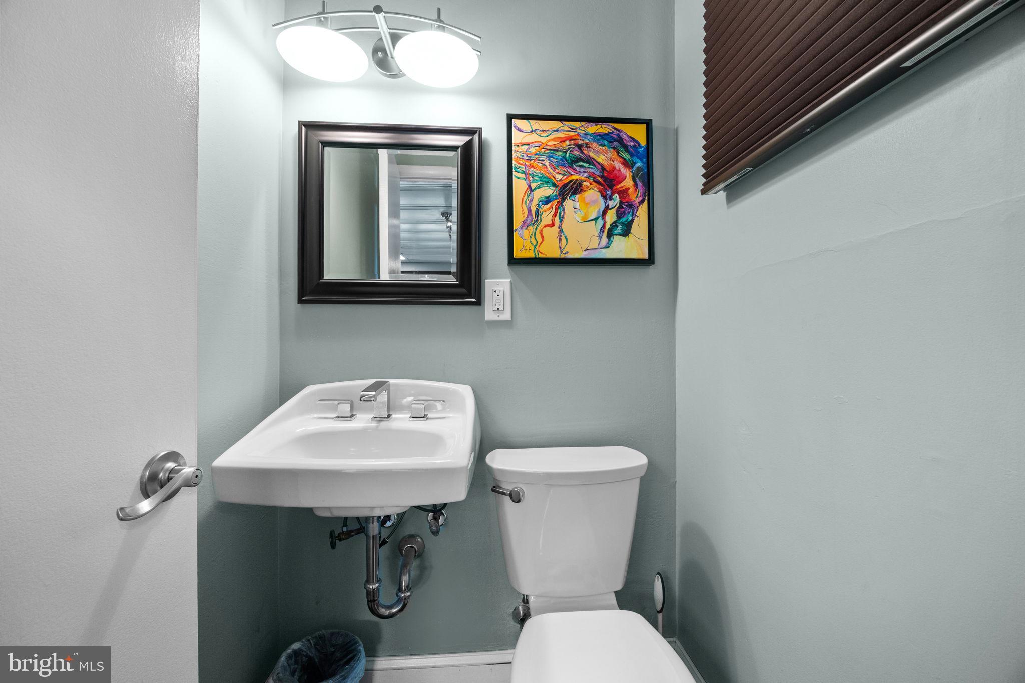 3166 Hulmeville Road Bensalem, PA 19020 - Photo 31 of 40 a bathroom with a toilet a sink and mirror