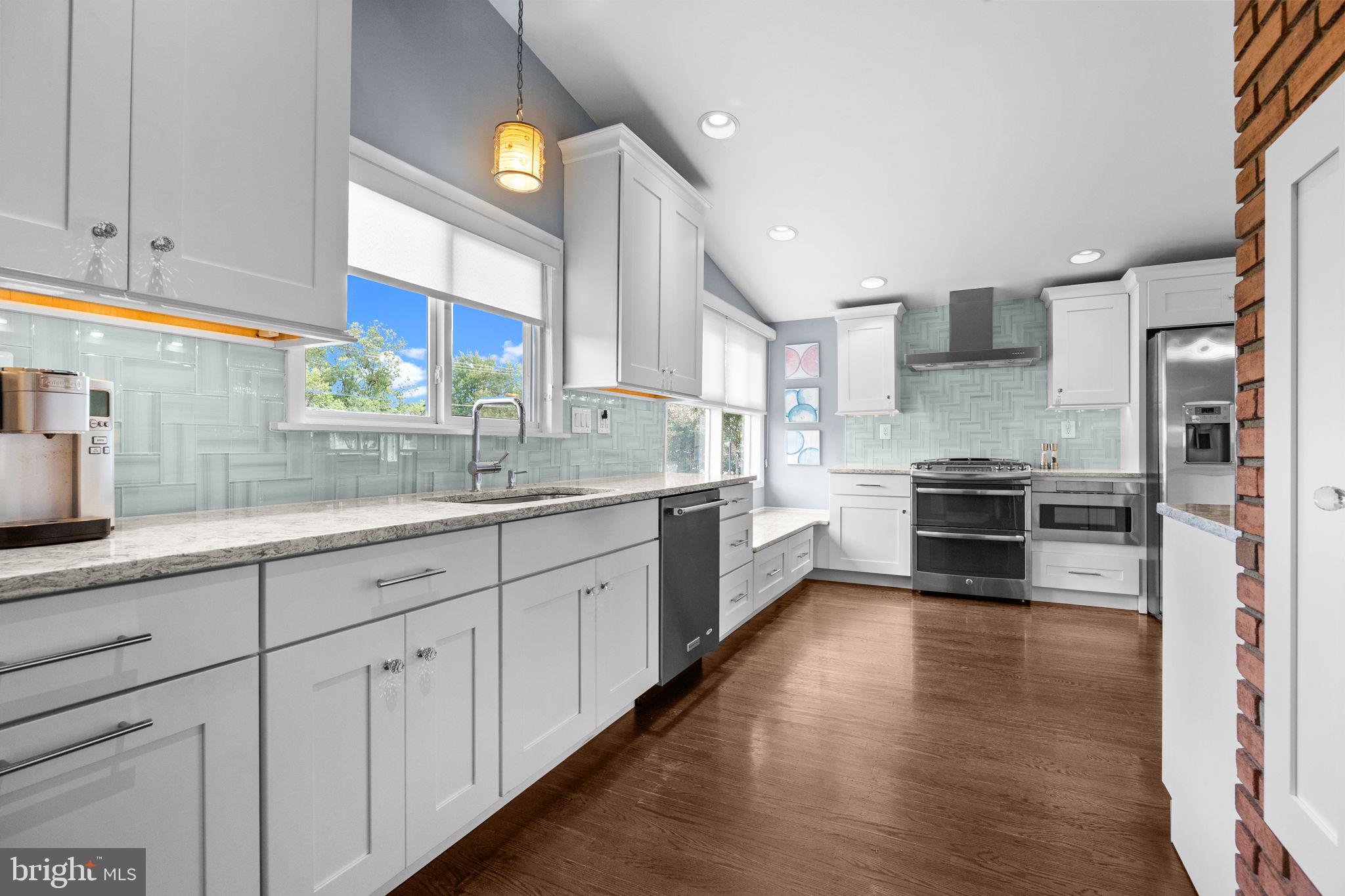 3166 Hulmeville Road Bensalem, PA 19020 - Photo 9 of 40 a large kitchen with a lot of counter space and wooden floor