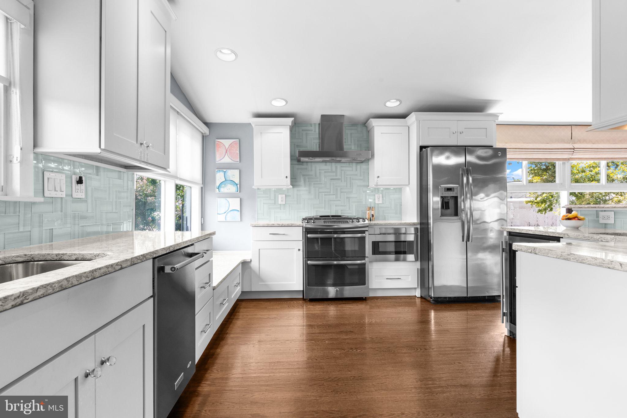 3166 Hulmeville Road Bensalem, PA 19020 - Photo 10 of 40 a kitchen with stainless steel appliances kitchen island granite countertop a refrigerator and a sink
