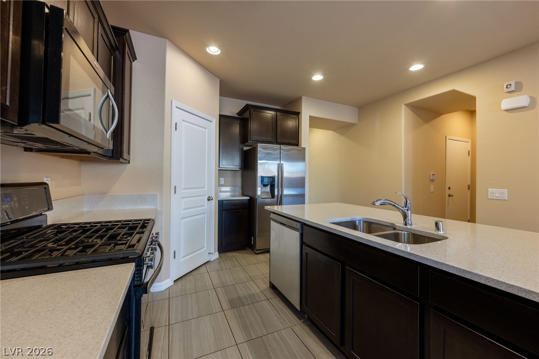 11016 Prairie Grove Road Las Vegas, NV 89179 - Photo 8 of 37 Culinary delights await in this modern kitchen, complete with premium stainless steel appliances and abundant counter space.