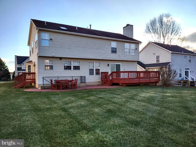 a front view of house with yard and outdoor seating