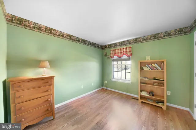 a view of house with yard and deck