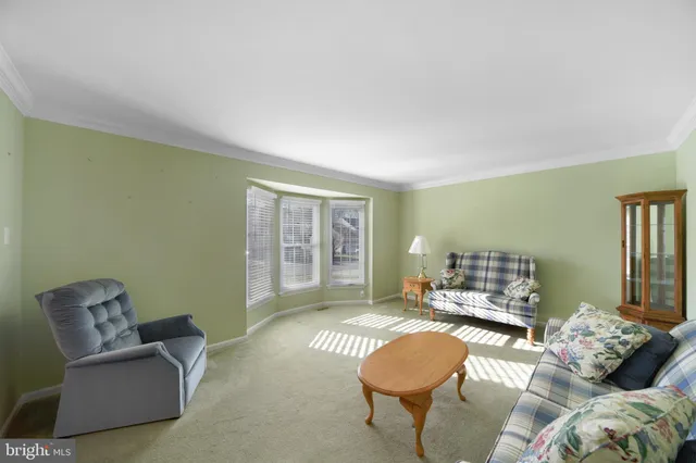 a living room with a couch and a dresser with wooden floor