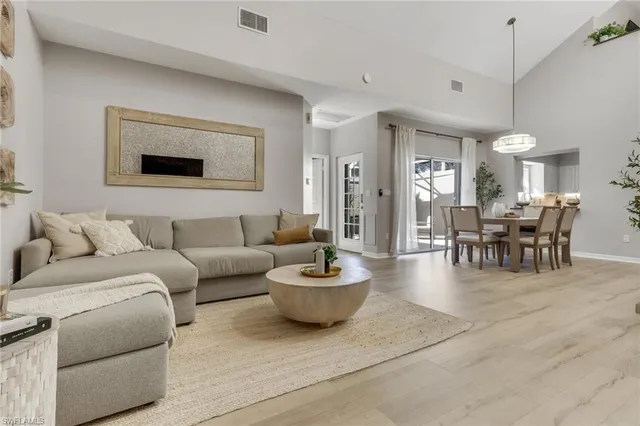 a living room with furniture and a dining table