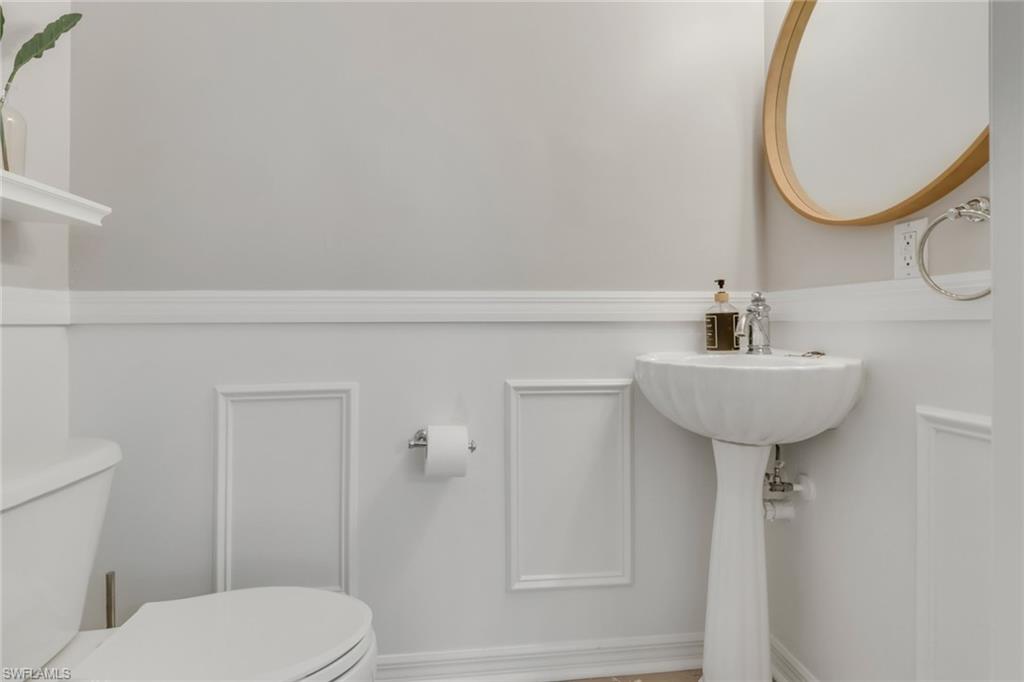 4536 Court Way, Unit 19D Naples, FL 34109 - Photo 12 of 27 a bathroom with a sink a mirror and a toilet