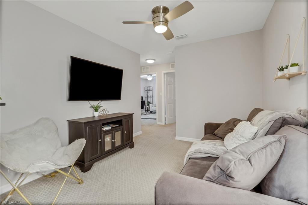 4536 Court Way, Unit 19D Naples, FL 34109 - Photo 13 of 27 a living room with furniture and a flat screen tv