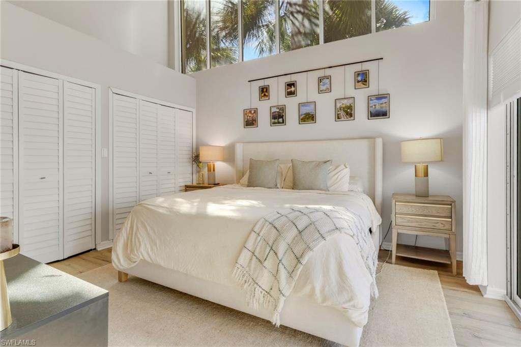 4536 Court Way, Unit 19D Naples, FL 34109 - Photo 18 of 27 a bedroom with a bed and a night stand