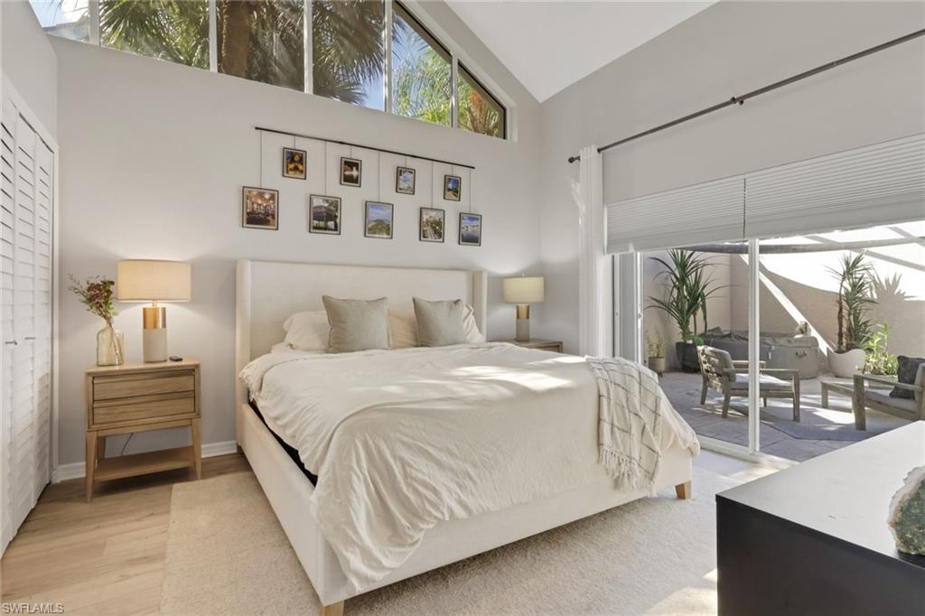4536 Court Way, Unit 19D Naples, FL 34109 - Photo 19 of 27 a bedroom with a bed and a large window