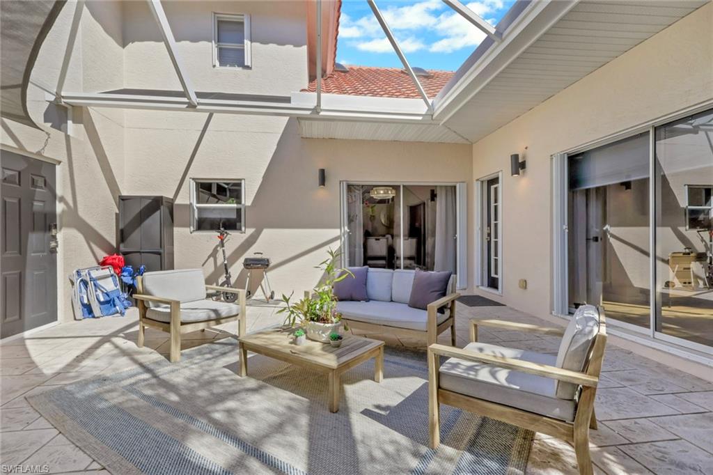 4536 Court Way, Unit 19D Naples, FL 34109 - Photo 25 of 27 a living room with furniture and a window