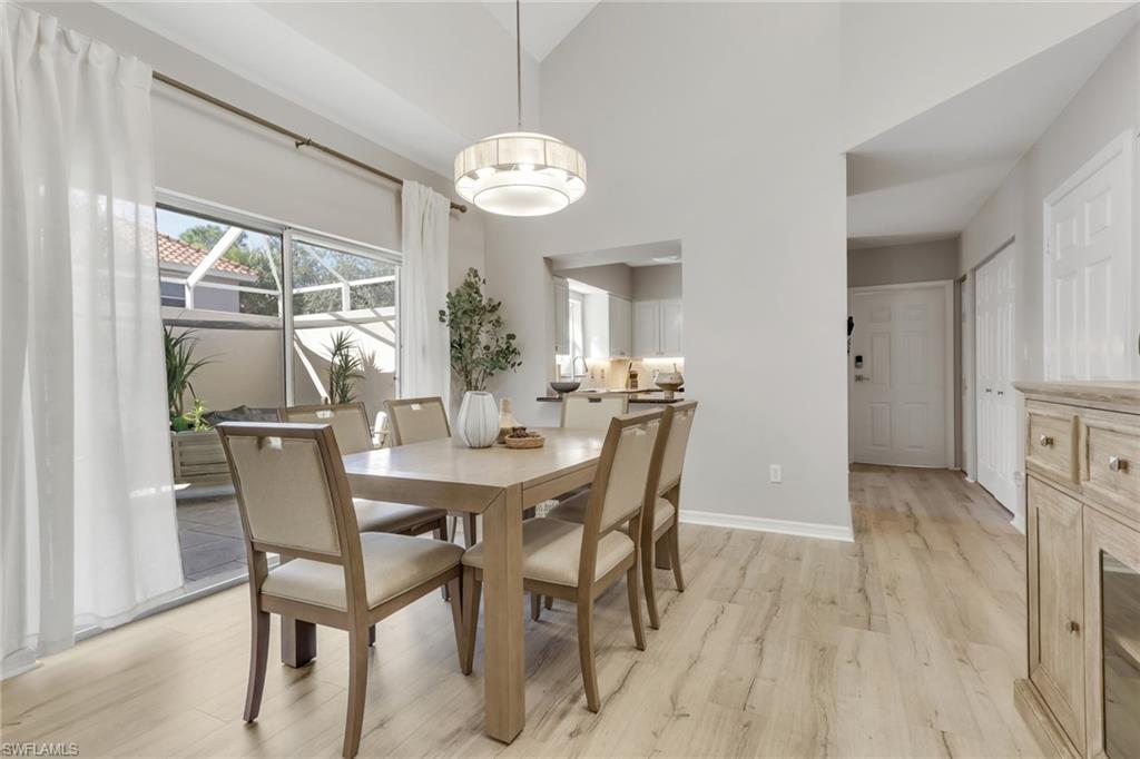 4536 Court Way, Unit 19D Naples, FL 34109 - Photo 7 of 27 a view of a dining room with furniture window and wooden floor