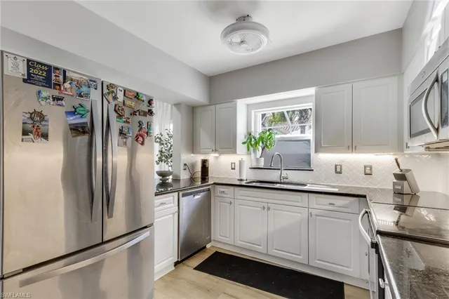 a kitchen with a sink stainless steel appliances and cabinets