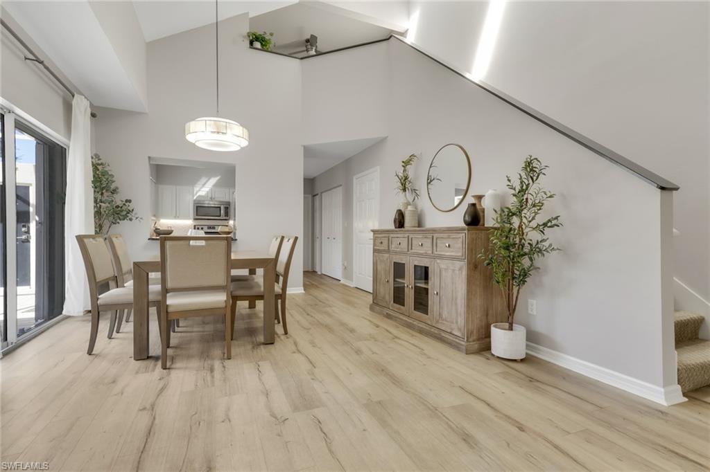 4536 Court Way, Unit 19D Naples, FL 34109 - Photo 10 of 27 a view of a dining room with furniture window and wooden floor