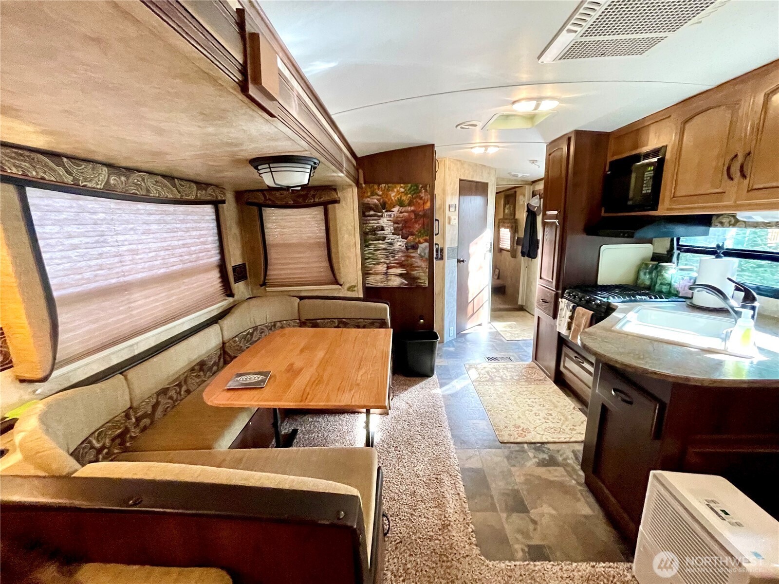 56 Butterfly Lane Pacific Beach, WA 98571 - Photo 17 of 29 a room with stainless steel appliances kitchen island granite countertop furniture and a flat screen tv