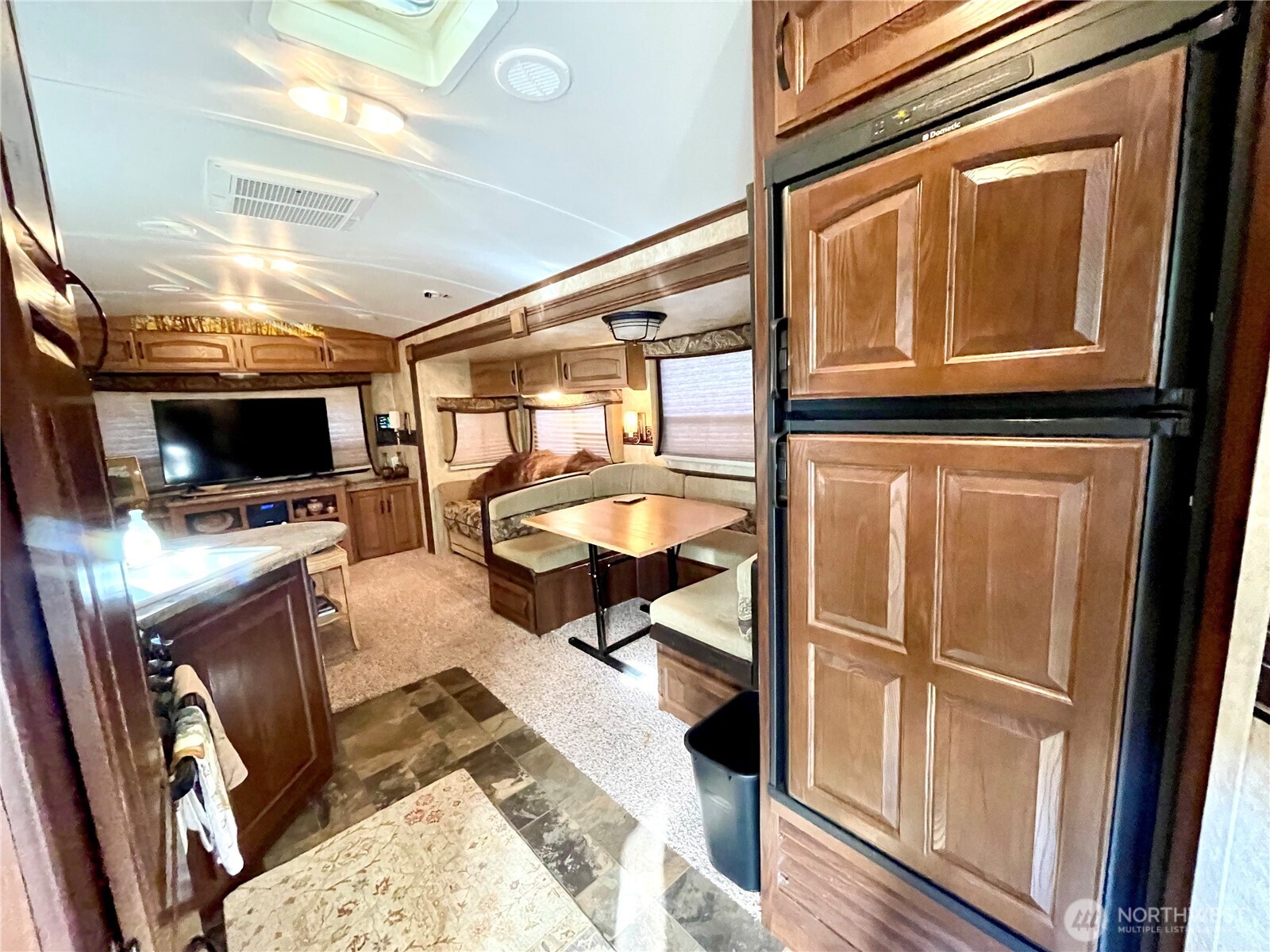 56 Butterfly Lane Pacific Beach, WA 98571 - Photo 23 of 29 a living room with furniture a flat screen tv and floor to ceiling window