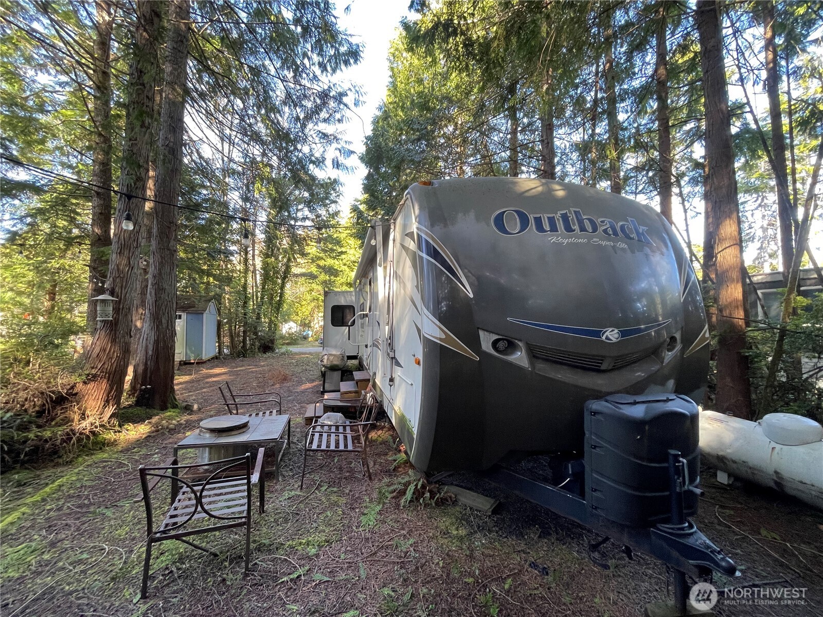 56 Butterfly Lane Pacific Beach, WA 98571 - Photo 4 of 29 a view of backyard with table and chairs and a fire pit