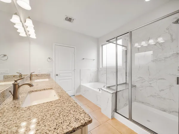 a bathroom with a tub sink and mirror