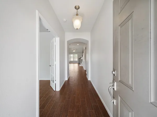 a view of a hallway with wooden floor