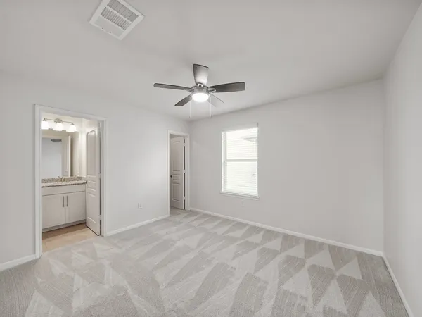a view of a livingroom with a ceiling fan and window