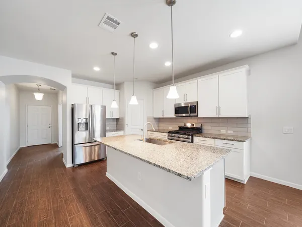a kitchen with a refrigerator a sink and a stove