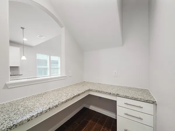 a bathroom with a granite countertop sink and dishwasher