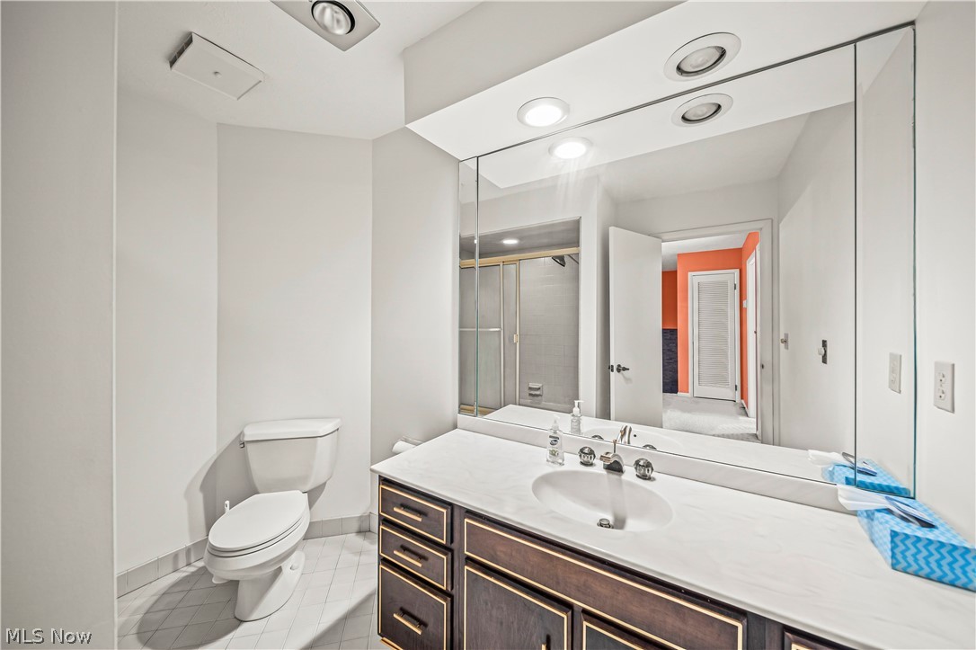 12200 Caves Road Chesterland, OH 44026 - Photo 28 of 43 Bathroom with tile flooring, toilet, and vanity with extensive cabinet space