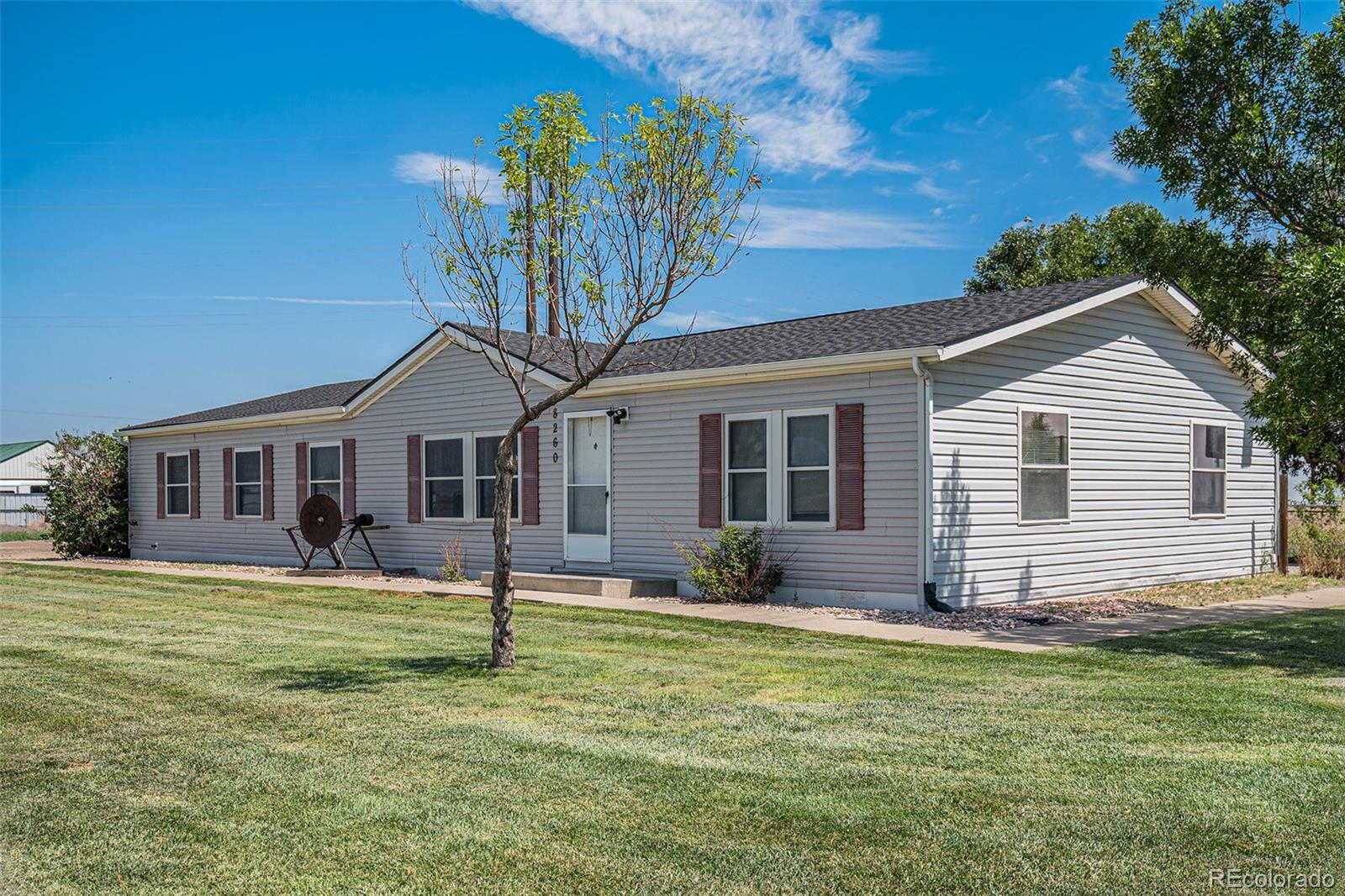 a front view of house with yard outdoor seating and barbeque oven
