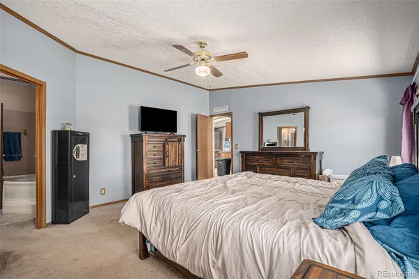 a bedroom with a large bed and a tv