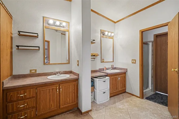 a spacious bathroom with a sink and a mirror