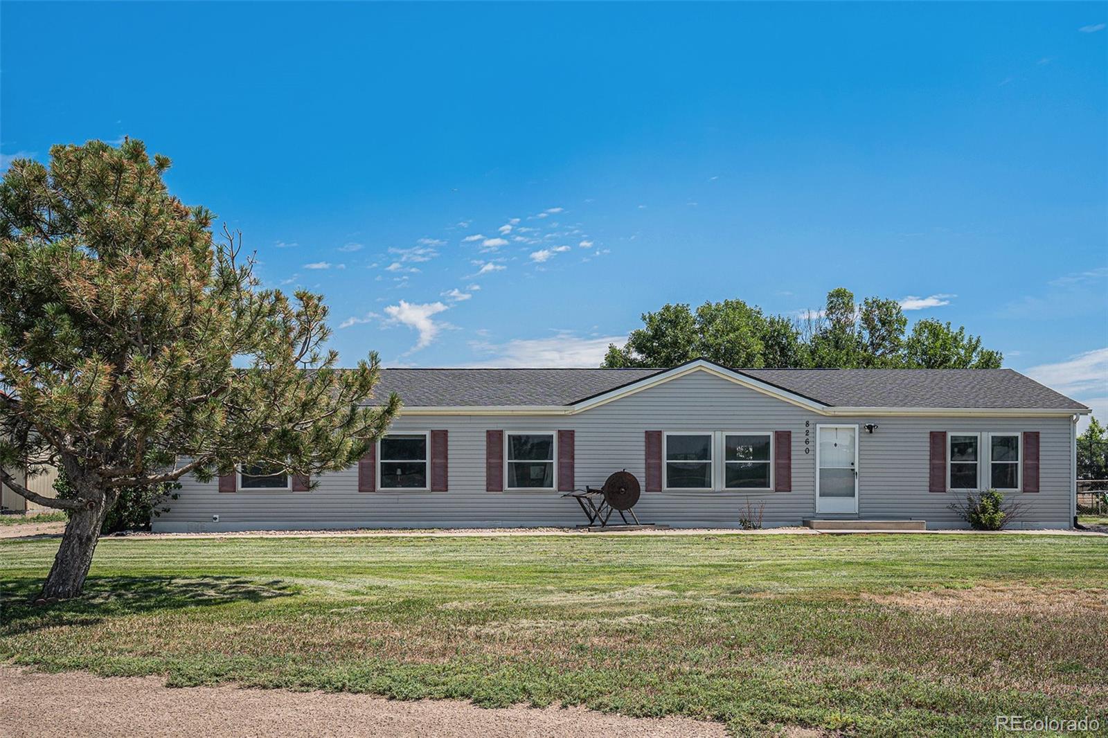 8260 County Road 39 Fort Lupton, CO 80621 - Photo 2 of 32 a front view of a house with a garden