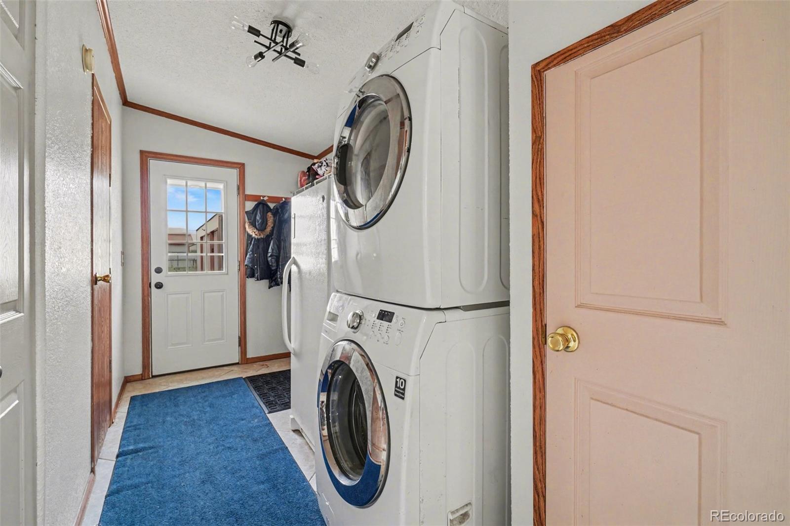 8260 County Road 39 Fort Lupton, CO 80621 - Photo 22 of 32 a view of a storage and utility room with washer and dryer