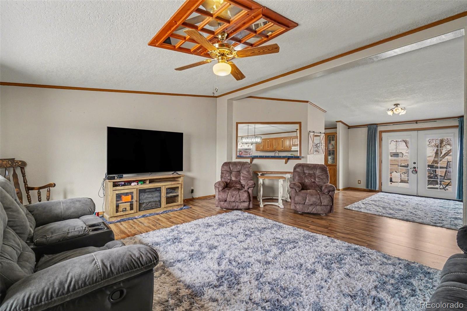 8260 County Road 39 Fort Lupton, CO 80621 - Photo 10 of 32 a living room with furniture and a flat screen tv
