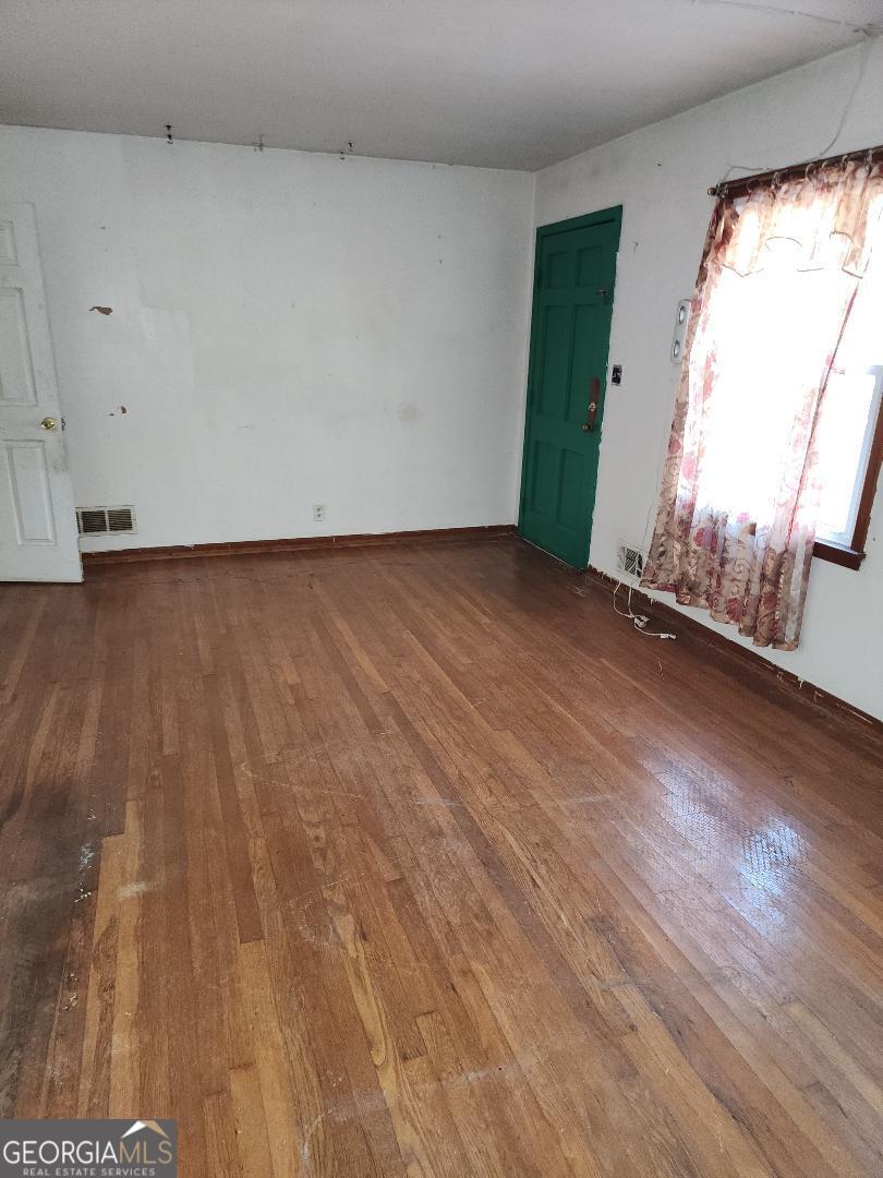 1521 Green Valley Court Conley, GA 30288 - Photo 2 of 6 a view of a room with wooden floor and window