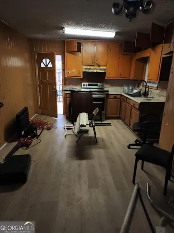 a kitchen with a sink stainless steel appliances and cabinets