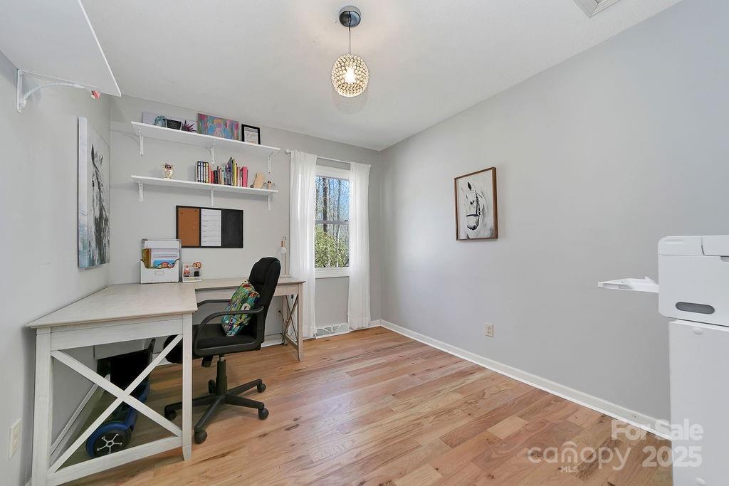 1881 Becky Mountain Road Brevard, NC 28712 - Photo 22 of 40 a workspace with furniture and wooden floor
